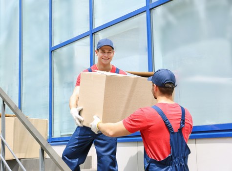 Movers navigating a tight central London access point during a business move