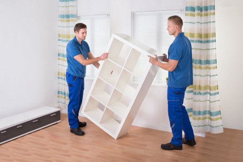 Professional movers handling furniture in a London apartment building