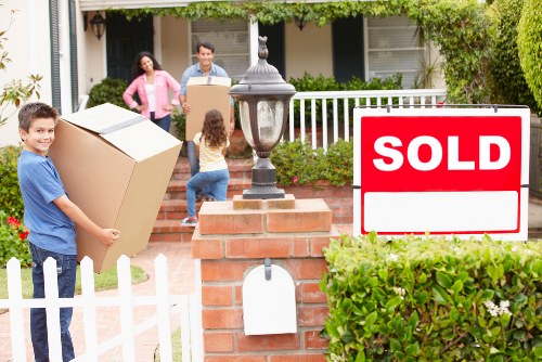 Local moving team organising boxes in a Lisson Grove flat