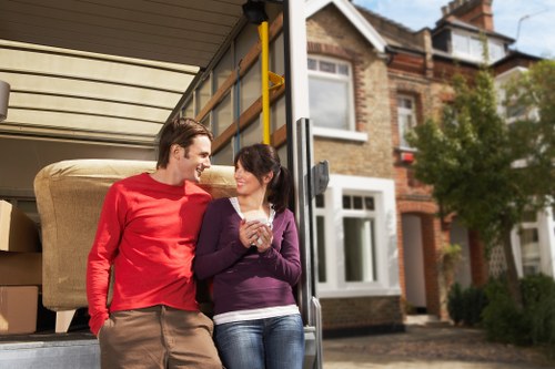 Worker assessing lifting risks before moving furniture